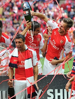 Arsenal V Manchester City - FA Community Shield 2014/15 Prints: Aaron Ramsey and Santi Cazorla (Arsenal) celebrate winning the community shield. Arsenal 3