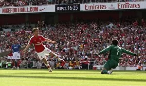 Images Dated 22nd August 2009: Aaron Ramsey scores Arsenals 4th goal past David James (Portsmouth)