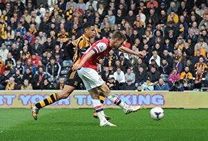 Images Dated 20th April 2014: Aaron Ramsey Scores Under Pressure Against Curtis Davies: Hull City vs Arsenal (2014)