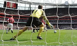 Arsenal v Manchester United 2010-2011 Collection: Aaron Ramsey shoots past Man United goalkeeper Edwin van der Sar to score the Arsenal goal