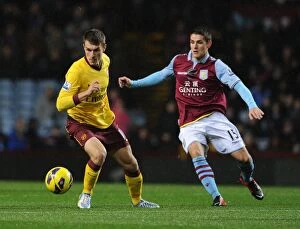 Images Dated 24th November 2012: Aaron Ramsey vs. Ashley Westwood: Intense Battle at Villa Park (Aston Villa v Arsenal)