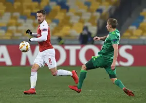 FC Vorskla Poltava V Arsenal 2018-19 Prints: Aaron Ramsey vs. Igor Perduta: Intense Clash in Arsenal's UEFA Europa League Match against Vorskla Poltava