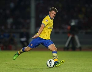 Indonesia Dream Team v Arsenal 2013-14 Collection: Aaron Ramsey vs Indonesia All-Stars: Arsenal Star Faces Off in 2013-14 Tour
