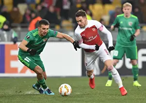 FC Vorskla Poltava V Arsenal 2018-19 Prints: Aaron Ramsey vs. Vyacheslav Sharpar: Clash in the Europa League between Arsenal and Vorskla Poltava