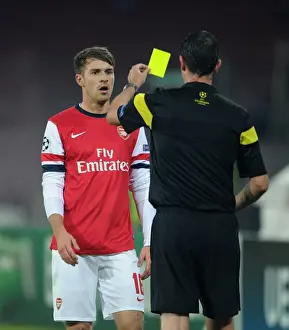 Napoli V Arsenal 2013-14 Prints: Aaron Ramsey Yellow Carded by Referee Viktor Kassai in Napoli v Arsenal UEFA Champions League Match