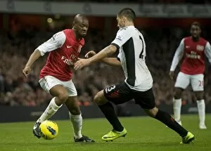 Abou Diaby of Arsenal takes on Clint Dempsey of Fulham during the Barclays Premier League match between Arsenal