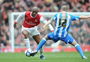 Images Dated 30th January 2011: Abou Diaby (Arsenal) Tom Clarke (Huddersfield). Arsenal 2: 1 Huddersfield Town