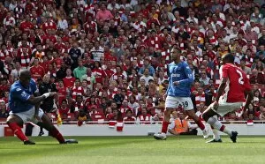 Abou Diaby scores Arsenals 1st goal past Sylvain Distin (Portsmouth)