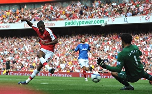 Abou Diaby shoots past Portsmouth goalkeeper David Abou Diaby shoots past Portsmouth goalkeeper David