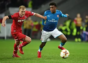 FC Koln V Arsenal 2017-18 Prints: Alex Iwobi Dashes Past Frederik Sorensen: Arsenal's Thrilling Moment against 1