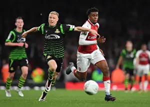Arsenal V Doncaster Rovers - Carabao Cup 2017-18 Prints: Alex Iwobi vs. Craig Alcock: A Carabao Cup Battle at Arsenal's Emirates Stadium