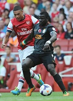 Images Dated 4th August 2013: Alex Oxlade-Chamberlain (Arsenal) Emmanuel Eboue (Galatasaray). Arsenal 1: 2 Galatasaray