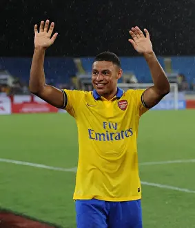 Vietnam V Arsenal 2013-14 Prints: Alex Oxlade-Chamberlain Bids Farewell: Arsenal's Star Waves to Vietnamese Fans (2013)
