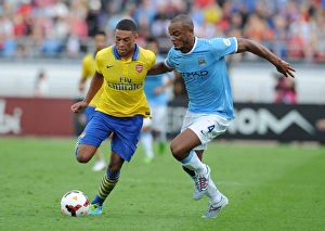 Arsenal V Manchester City Pre Season 2013-14 Prints: Alex Oxlade-Chamberlain Outwits Vincent Kompany: Arsenal's Agile Midfielder Dazzles Manchester City's Defender