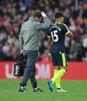 Southampton V Arsenal 2016-17 Prints: Alex Oxlade-Chamberlain Receives Treatment from Physio Colin Lewin during Southampton Match