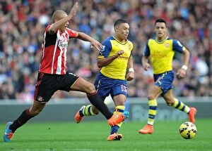 Sunderland v Arsenal 2014/15 Collection: Alex Oxlade-Chamberlain Surges Past Wes Brown in Sunderland vs. Arsenal Premier League Clash