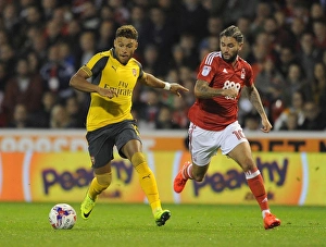 Nottingham Forest V Arsenal EPL Cup 3rd Round 2016-17 Prints: Alex Oxlade-Chamberlain vs. Henri Lansbury: A Battle in the EFL Cup Third Round between Nottingham Forest and Arsenal