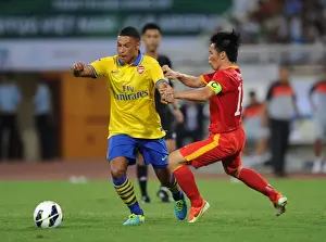 Vietnam V Arsenal 2013-14 Prints: Alex Oxlade-Chamberlain vs Le Tan Tai: Vietnam vs Arsenal Friendly, 2013