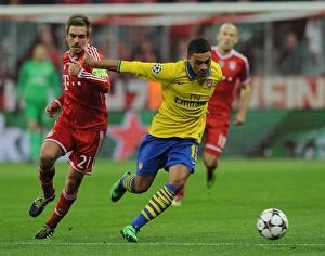 Images Dated 11th March 2014: Alex Oxlade-Chamberlain vs. Philipp Lahm: Battle at the Allianz Arena - Arsenal vs