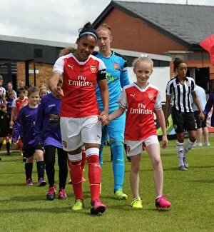 Alex Scott (Arsenal Ladies) and the mascot before the match