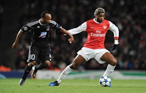 Arsenal v Partizan Belgrade 2010-11 Collection: Alex Song (Arsenal) Almami Moreira (Partizan). Arsenal 3: 1 Partizan Belgrade