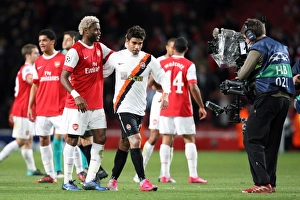 Arsenal v Shaktar Donetsk 2010 - 11 Collection: Alex Song (Arsenal) with Eduardo (Shaktar) the former Arsenal player after the match