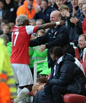 Images Dated 30th October 2010: Alex Song celebrates scoring the Arsenal goal with masseur John Kelly. Arsenal 1