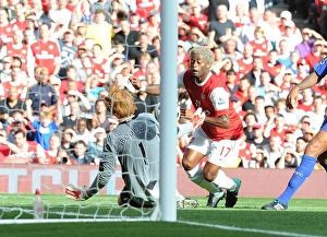 Arsenal v Bolton Wanderers 2010-11 Collection: Alex Song chips the ball over Bolton goalkeeper Adam Bogan to score the 3rd Arsenal goal