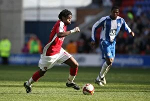 Wigan Athletic v Arsenal 2008-09 Collection: Alex Song's Dominance: Arsenal Crush Wigan Athletic 4-1 in Premier League