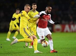 Images Dated 14th February 2019: Alexandre Lacazette vs Zakhar Volkov: Clash in the Europa League as Arsenal Face BATE Borisov