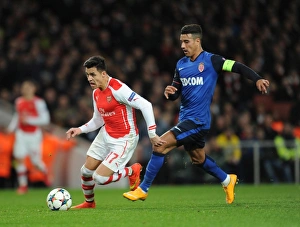 Arsenal v Monaco 2104/15 Collection: Alexis Sanchez (Arsenal) Nabil Dirar (Monaco). Arsenal 1: 3 AS Monaco. UEFA Champions League