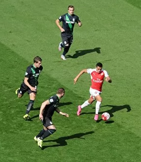 Arsenal v Stoke City 2015-16 Collection: Alexis Sanchez (Arsenal) takes on Xherdan Shaqiri, Marco van Ginkel and Phil Bardsley