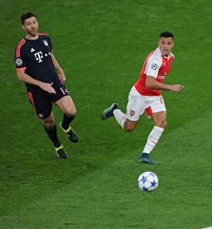Images Dated 20th October 2015: Alexis Sanchez Outsmarts Xabi Alonso: Arsenal vs. Bayern Munich Champions League Showdown (2015/16)
