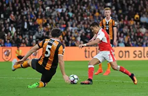 Alexis Sanchez scores his 2nd goal for Arsenal beating Harry McGuire (Hull) on the way
