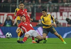 Images Dated 15th February 2017: Alexis Sanchez vs Xabi Alonso: Battle in Munich - Arsenal vs Bayern Munich