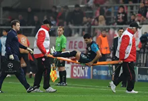 Olympiacos V Arsenal 2011-12 Prints: Andre Santos Carried Off Injured: Olympiacos vs Arsenal, UEFA Champions League, 2011