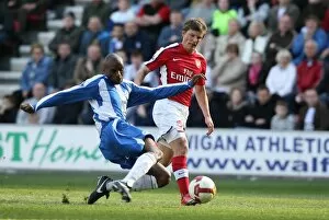 Images Dated 11th April 2009: Andrey Arshavin (Arsenal) Emerson Boyce (Wigan)