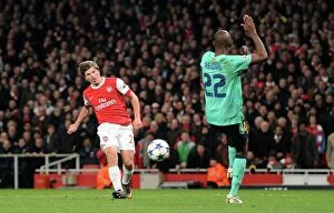 Images Dated 16th February 2011: Andrey Arshavin scores Arsenals 2nd goal under pressure from Eric Abidal (Barcelona)