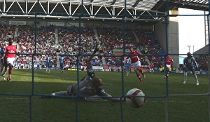 Images Dated 11th April 2009: Andrey Arshavin scores Arsenals 3rd goal past Chris Kirkland (Wigan)