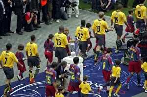 Images Dated 8th April 2008: The Arsenal and Barcelona teams walk out past the European Cup