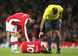 Arsenal captain Cesc Fabregas attends injured defender William Gallas
