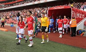 Arsenal v Wigan Athletic 2009-10 Collection: Arsenal captain Cesc Fabregas followed by Vito Mannone
