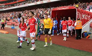 Arsenal captain Cesc Fabregas followed by Vito Mannone