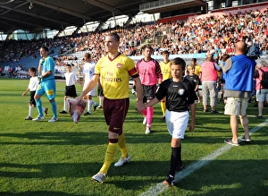 Arsenal captain Thomas Vermaelen leads the team out before the match. Sturm Graz 0 Arsenal captain Thomas Vermaelen leads the team out before the match. Sturm Graz 0