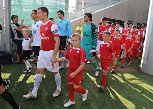 Arsenal captain Thomas Vermaelen leads out the team before the match. Legia Warsaw 5 Arsenal captain Thomas Vermaelen leads out the team before the match. Legia Warsaw 5