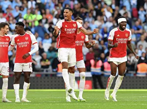 Arsenal Celebrate Community Shield Victory: Arsenal Players, Including William Saliba, Rejoice after Defeating Manchester City (2023-24)