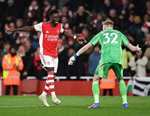 Images Dated 24th February 2022: Arsenal Celebrate Win Against Wolverhampton Wanderers: Bukayo Saka and Aaron Ramsdale