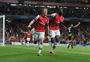 Uefa Champions Laegue Collection: Arsenal Double Strike: Ramsey and Sanogo Celebrate Champions League Goals (2013-14)