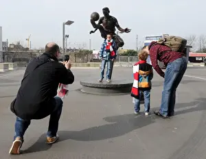 Arsenal V Everton - FA Cup 2014 Prints: Arsenal FA Cup Quarter-Final: Fans Gather Around Dennis Bergkamp Statue