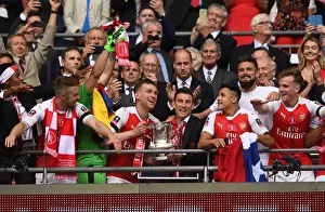 Arsenal V Chelsea - FA Cup Final 2017 Prints: Arsenal FA Cup Victory: Per Mertesacker and Laurent Koscielny Celebrate with the Trophy after Beating Chelsea 2-1